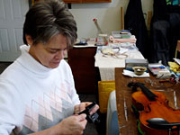 Jan Hampton repairing an instrument